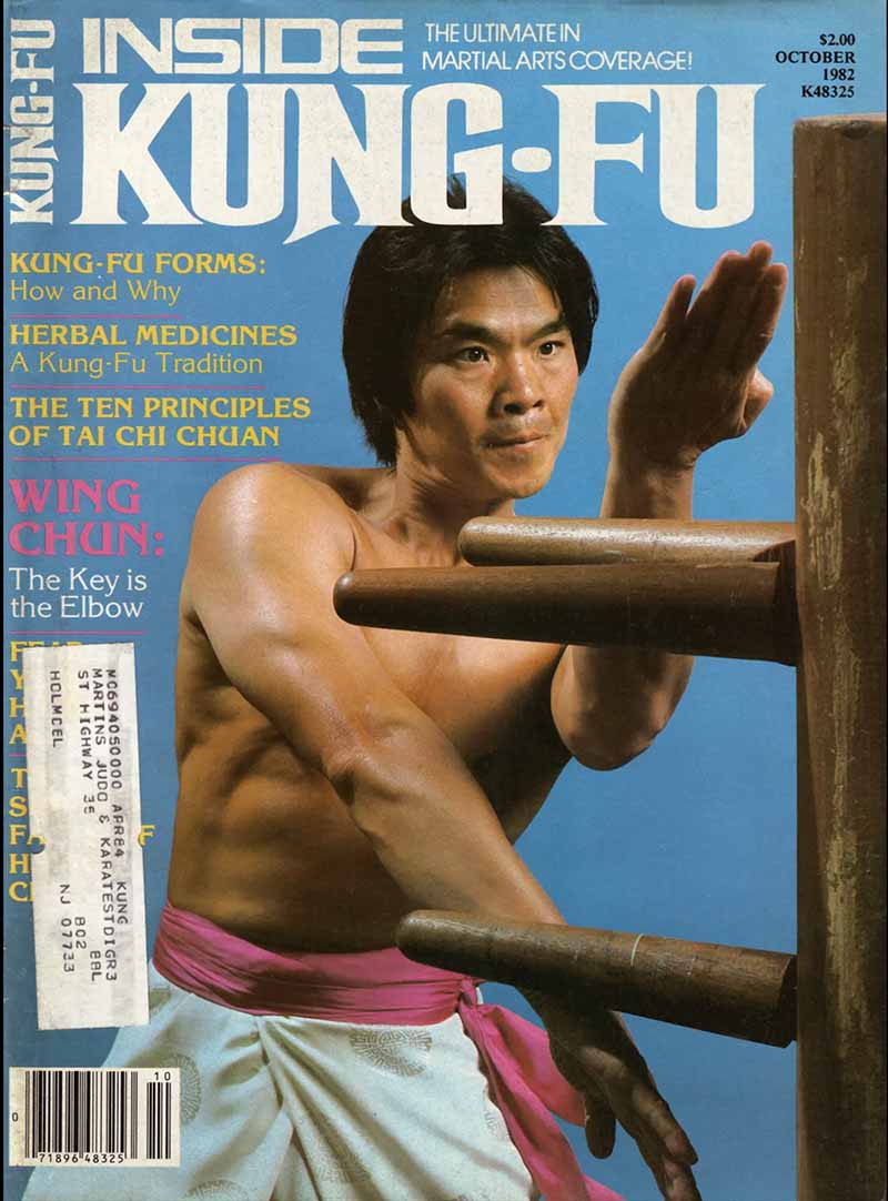 Grandmaster William Cheung training at the wooden dummy, wearing the purple sash